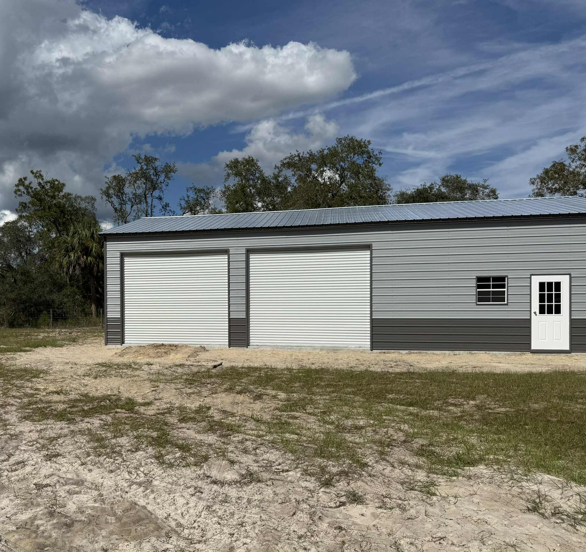 Large grey metal workshop with white trim